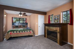 bedroom with queen bed and fireplace