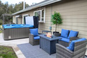 patio with outdoor seating, fire pit, and hot tub