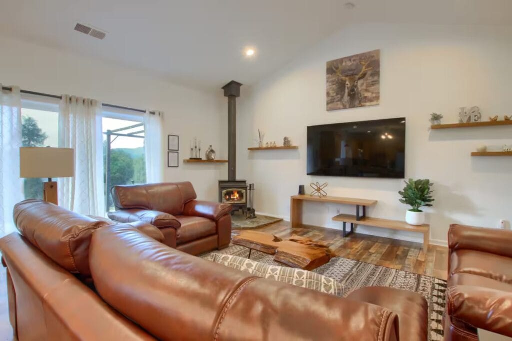 living room wit large sectional couch, television and fireplace